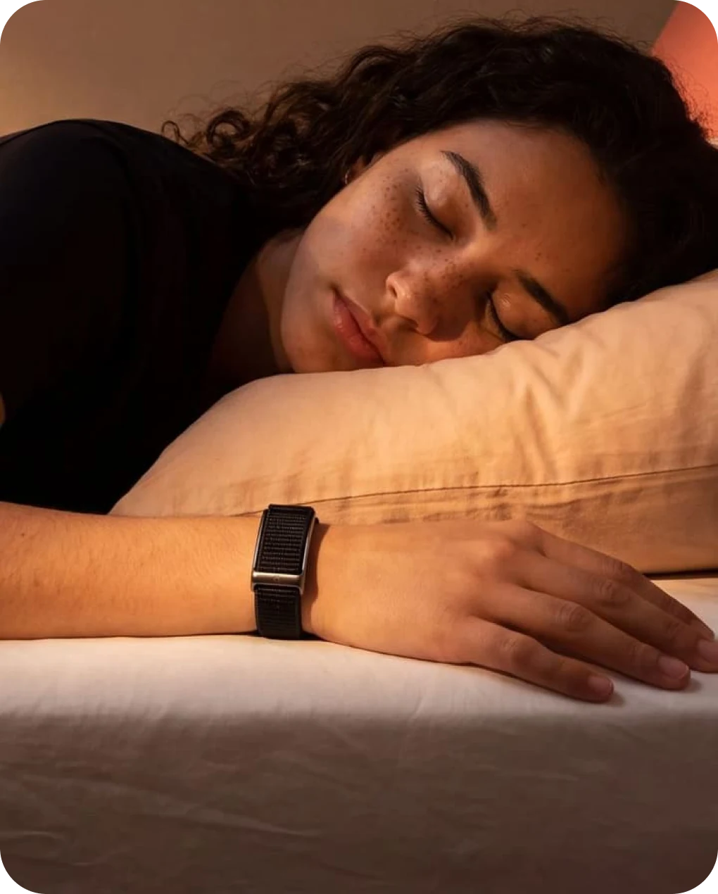 Woman asleep on her pillow wearing the HLTH Band